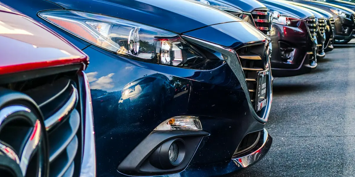Front of a blue car in a row of vehicles
